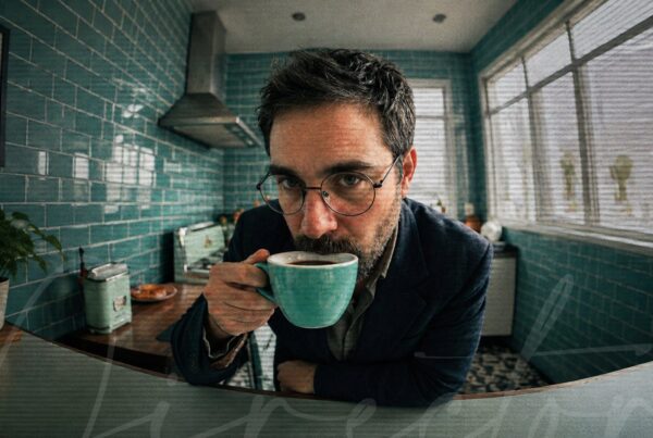 Ahmad Abu Goura, Creative Director at AGSketches, drinking coffee in a teal-tiled kitchen